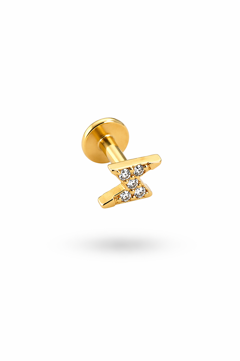 goldenes piercing in blitz form mit zirkonia steinchen drauf